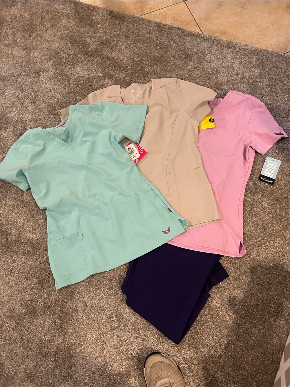 Small bundle of scrub tops and one pair of scrub bottoms